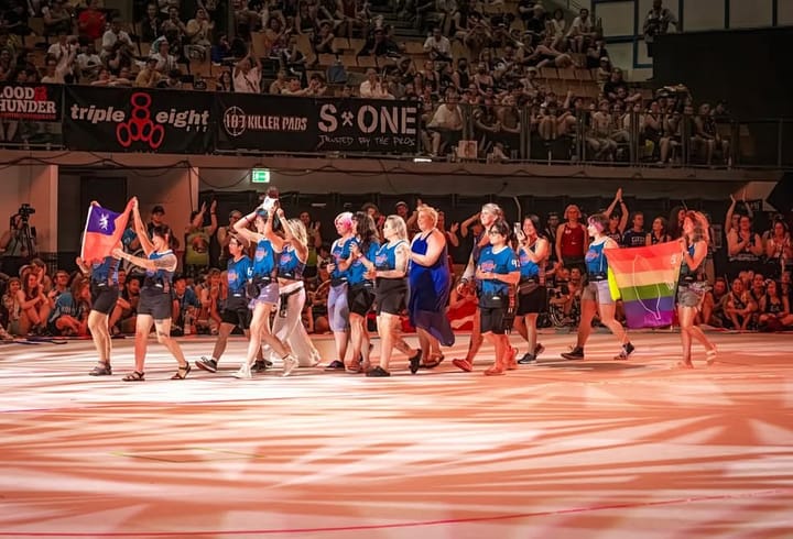 Group of skaters for Team Taiwan holding national flags during the Roller Derby World Cup Parade of Nations
