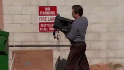 Ron Swanson putting his computer in a dumpster