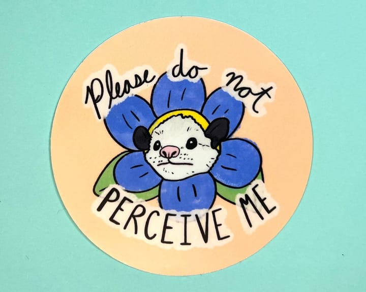 Sticker with a drawing of a possum in the middle of a flower, with the words "Please do not perceive me"